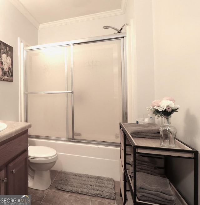 4650 Perry Rd, Gainesville, GA 30506 - bathroom featuring vanity, ornamental molding, toilet, bath / shower combo with glass door, and tile patterned floors