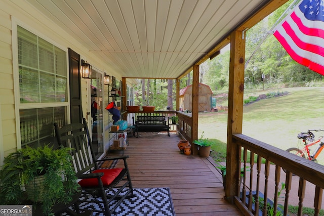 4650 Perry Rd, Gainesville, GA 30506 - wooden terrace with a storage shed, a lawn, an outbuilding, and covered porch