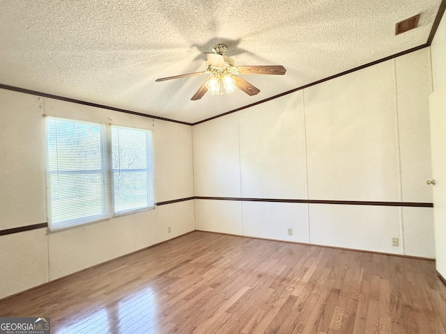 33 Keen Rd, Summerville, GA 30747 - spare room with light wood-style flooring, ornamental molding, a textured ceiling, and ceiling fan