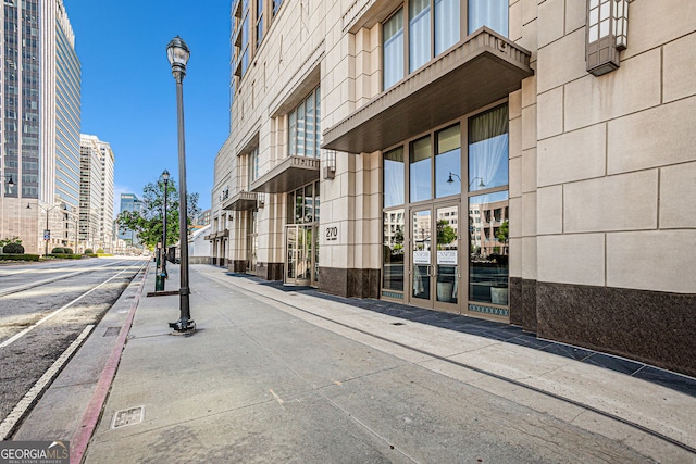 view of road with curbs, street lighting, and sidewalks