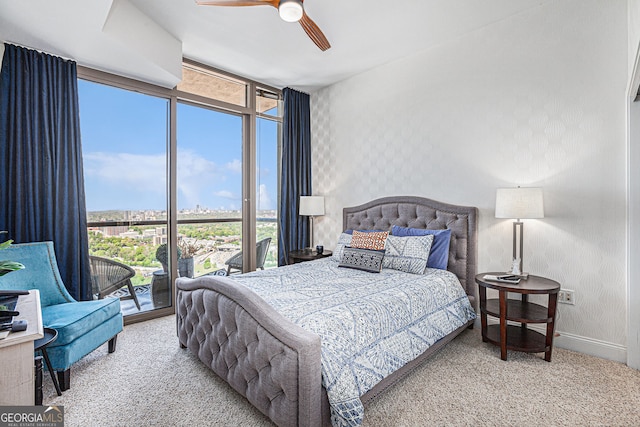 bedroom with baseboards, access to exterior, wallpapered walls, and carpet