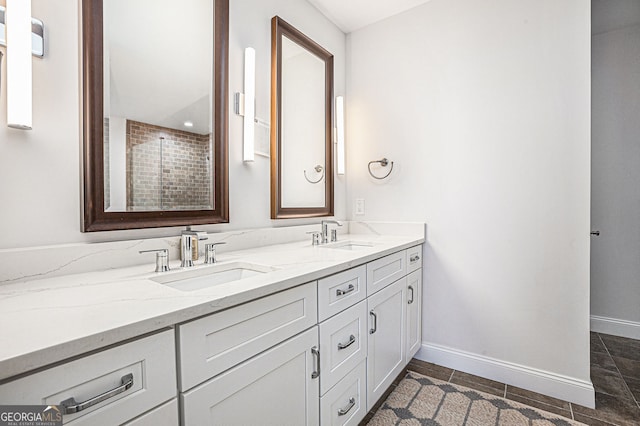 bathroom with baseboards, a sink, and double vanity