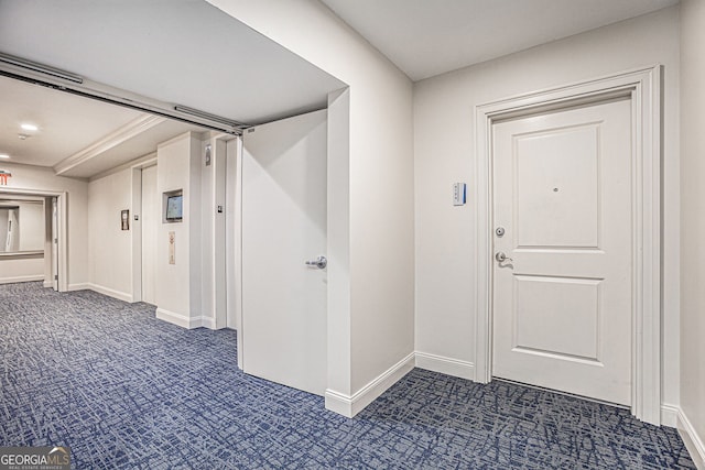 corridor with carpet and baseboards