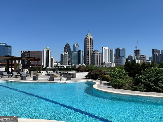 community pool featuring a patio area and a view of city