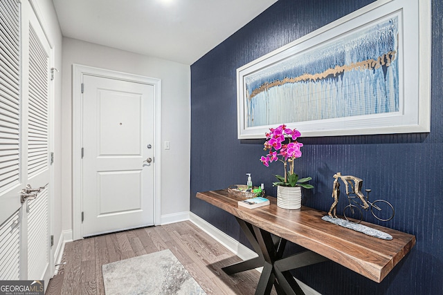 entryway with wood finished floors and baseboards
