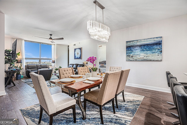 dining area featuring a wall of windows, dark wood finished floors, baseboards, and ceiling fan with notable chandelier