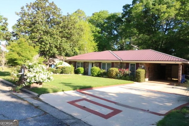 single story home with driveway, a front yard, a carport, and metal roof