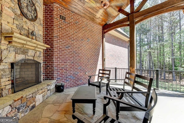 view of patio with an outdoor stone fireplace