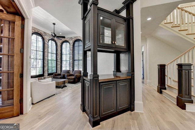 interior space featuring baseboards, recessed lighting, stairway, crown molding, and light wood finished floors