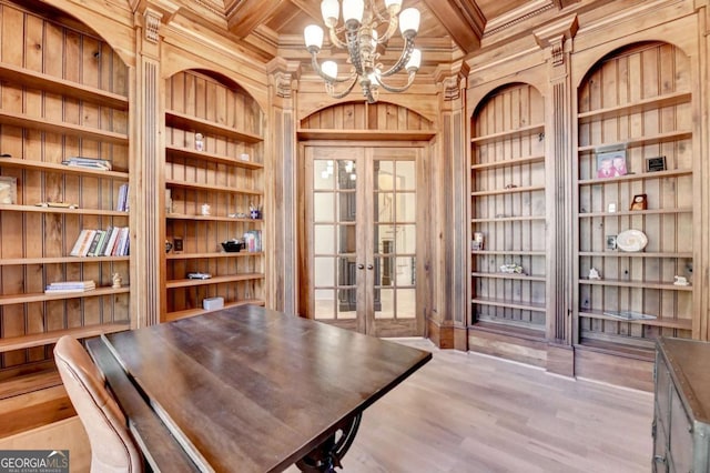 interior space featuring an inviting chandelier, wooden walls, french doors, beamed ceiling, and coffered ceiling