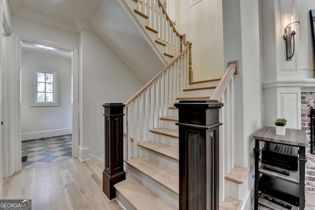 stairway with wine cooler and wood finished floors