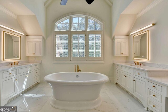 bathroom with a sink, baseboards, two vanities, and marble finish floor