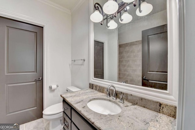 bathroom with vanity, ornamental molding, and toilet