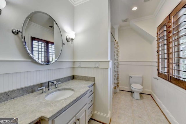 full bathroom with tile patterned floors, visible vents, crown molding, and wainscoting