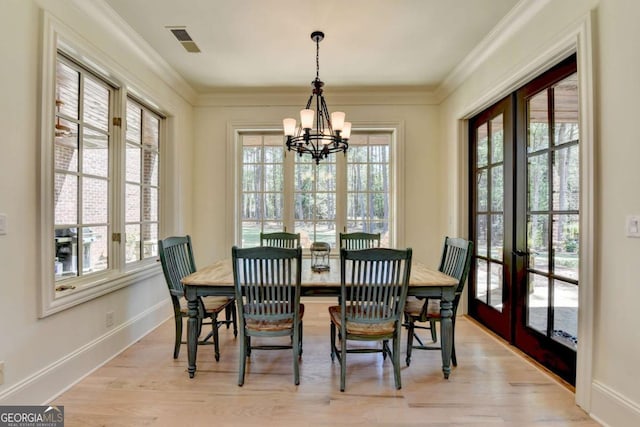 dining room featuring french doors, an inviting chandelier, visible vents, and a wealth of natural light