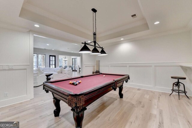 game room featuring a decorative wall, visible vents, recessed lighting, and a tray ceiling
