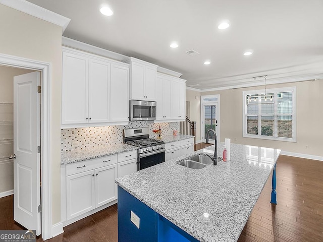 4343 Ainsley Mill Ln, Duluth, GA 30097 - kitchen with visible vents, a kitchen island with sink, a sink, stainless steel appliances, and dark wood-style floors