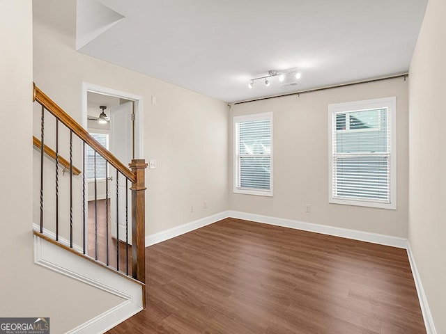 4343 Ainsley Mill Ln, Duluth, GA 30097 - spare room with wood finished floors, ceiling fan, baseboards, and stairs