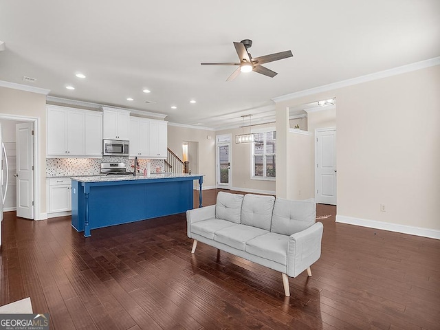 4343 Ainsley Mill Ln, Duluth, GA 30097 - living area featuring stairs, dark wood-type flooring, ornamental molding, and a ceiling fan