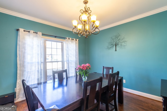 dining room featuring a chandelier, crown molding, wood finished floors, and baseboards