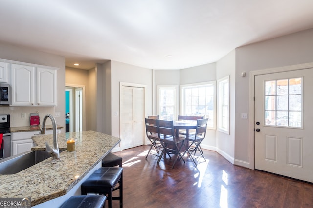 1036 Regency Park Dr, Braselton, GA 30517 - kitchen featuring a sink, electric range oven, white cabinets, dark wood-style floors, and recessed lighting