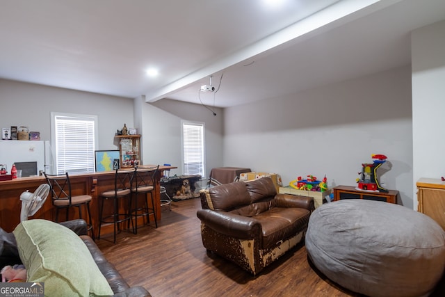 living area with wood finished floors and a dry bar