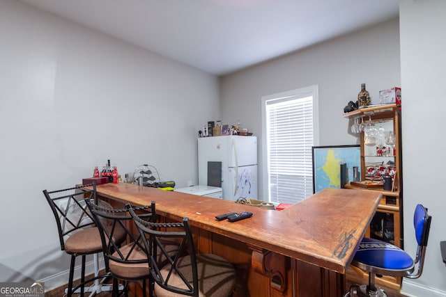 office area with baseboards and wood finished floors