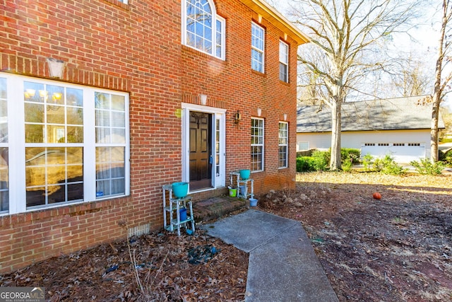 entrance to property featuring brick siding