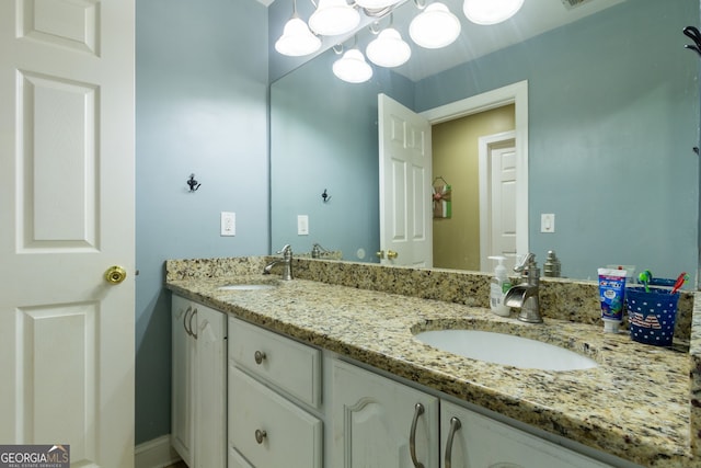 bathroom featuring a sink and double vanity