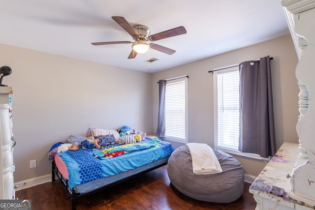 bedroom with visible vents, ceiling fan, baseboards, and wood finished floors