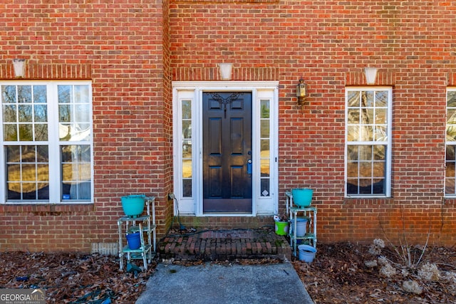 property entrance with brick siding