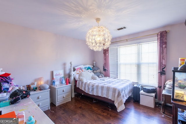 bedroom with dark wood-style flooring, a notable chandelier, and visible vents