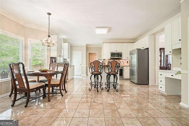 dining area featuring a chandelier, ornamental molding, and baseboards