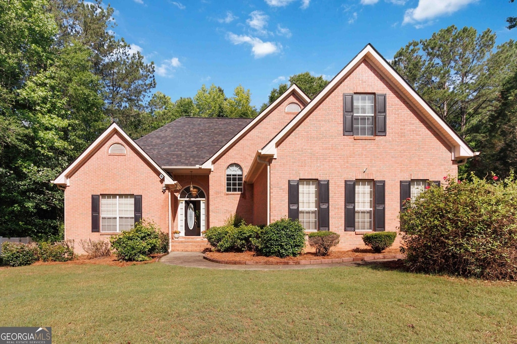 219 Garden Walk W, Hampton, GA 30228 - traditional home featuring brick siding and a front yard