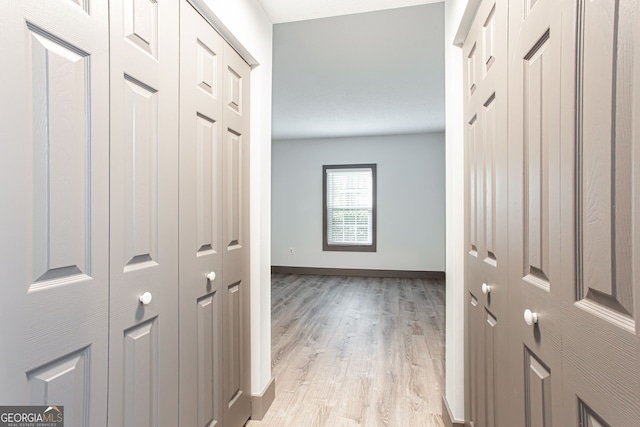 1074 Peachtree Walk NE Unit 115, Atlanta, GA 30309 - corridor featuring baseboards and light wood finished floors