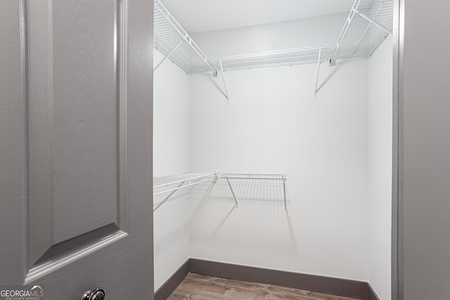 1074 Peachtree Walk NE Unit 115, Atlanta, GA 30309 - walk in closet with wood finished floors