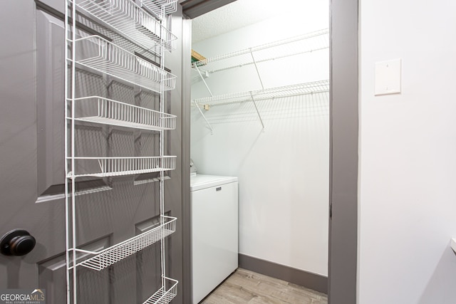 1074 Peachtree Walk NE Unit 115, Atlanta, GA 30309 - washroom featuring washer / dryer and light wood-style floors