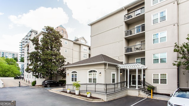 1074 Peachtree Walk NE Unit 115, Atlanta, GA 30309 - view of apartment building / complex with uncovered parking