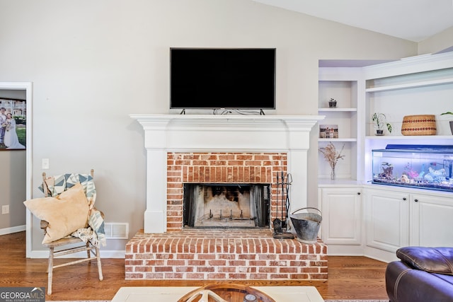 524 Allison Ln, Ball Ground, GA 30107 - living room featuring wood finished floors, a fireplace, and vaulted ceiling
