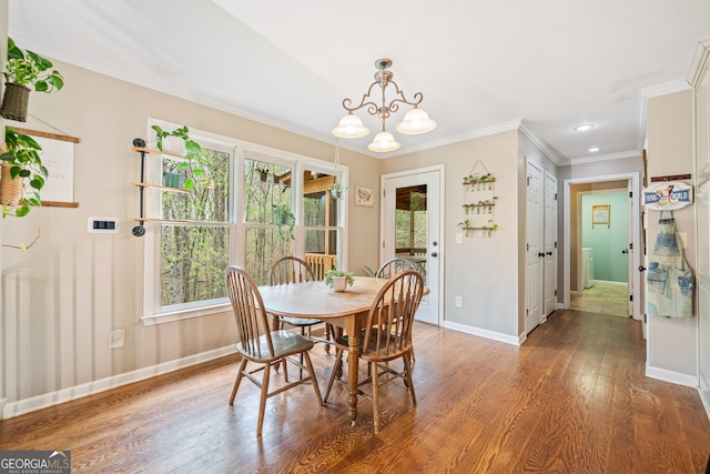524 Allison Ln, Ball Ground, GA 30107 - dining space with wood finished floors, a chandelier, healthy amount of natural light, and ornamental molding