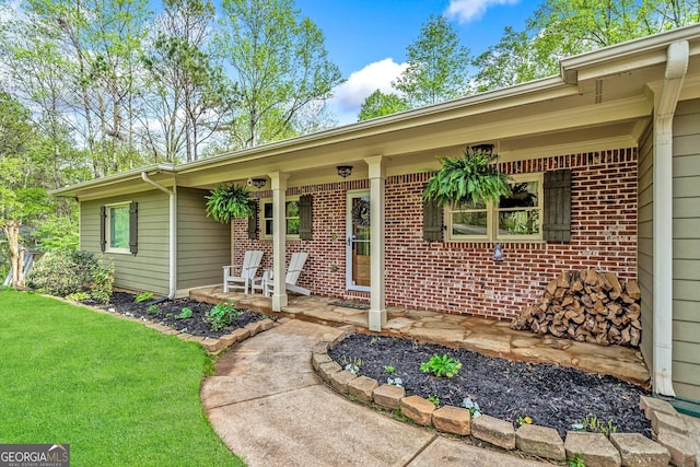524 Allison Ln, Ball Ground, GA 30107 - property entrance featuring a porch, brick siding, and a lawn