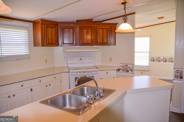 2055 Payne Pond Rd, Weston, GA 31832 - kitchen featuring light countertops, under cabinet range hood, white range with electric stovetop, pendant lighting, and a sink