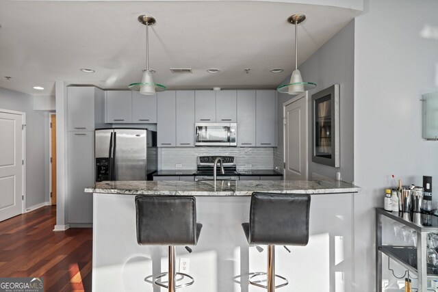 3324 Peachtree Rd NE Unit 1518, Atlanta, GA 30326 - kitchen with a breakfast bar area, visible vents, decorative backsplash, and appliances with stainless steel finishes