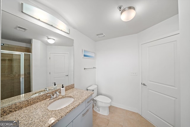 3324 Peachtree Rd NE Unit 1518, Atlanta, GA 30326 - bathroom featuring vanity, tile patterned flooring, toilet, a shower stall, and visible vents