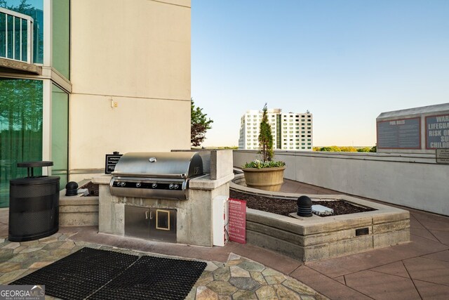 3324 Peachtree Rd NE Unit 1518, Atlanta, GA 30326 - patio terrace at dusk with exterior kitchen and grilling area