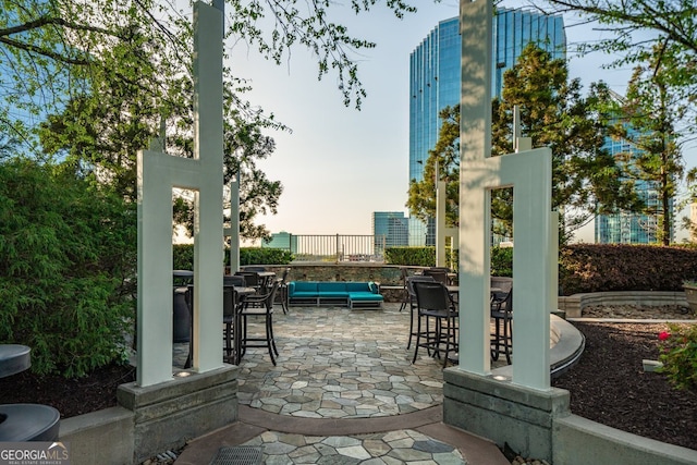 3324 Peachtree Rd NE Unit 1518, Atlanta, GA 30326 - patio terrace at dusk with outdoor dining space and an outdoor hangout area