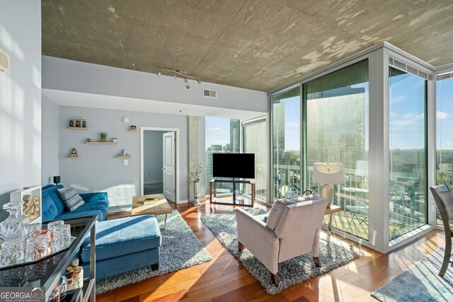 3324 Peachtree Rd NE Unit 1518, Atlanta, GA 30326 - living area with a healthy amount of sunlight, visible vents, wood finished floors, and a wall of windows