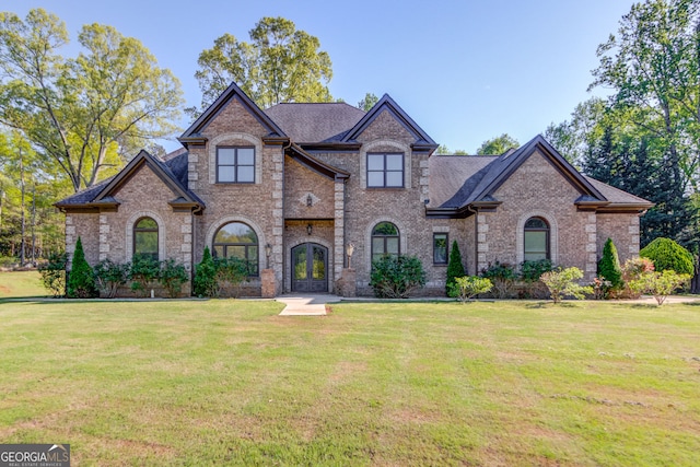 476 Walnut Rd, Hoschton, GA 30548 - view of front of home with brick siding, french doors, and a front lawn