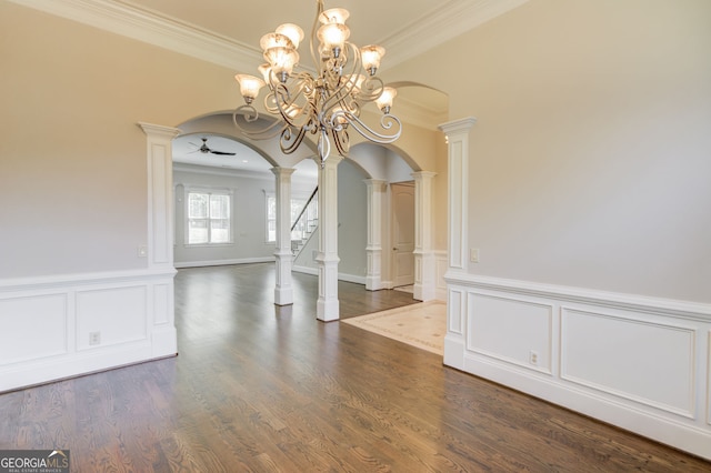 476 Walnut Rd, Hoschton, GA 30548 - unfurnished dining area with arched walkways, decorative columns, ornamental molding, a wainscoted wall, and a decorative wall