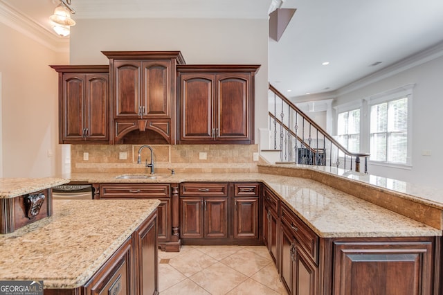 476 Walnut Rd, Hoschton, GA 30548 - kitchen with ornamental molding, tasteful backsplash, light stone counters, light tile patterned floors, and a peninsula